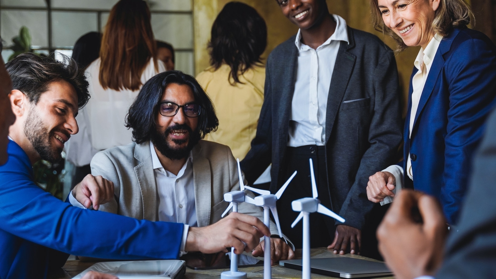 Happy business people work on sustainable renewable energy project inside office - Eco electricity